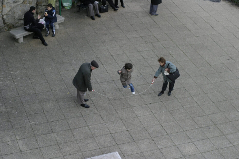 Mia and Mason Esworthy Two elderly people playing jump rope with a child
