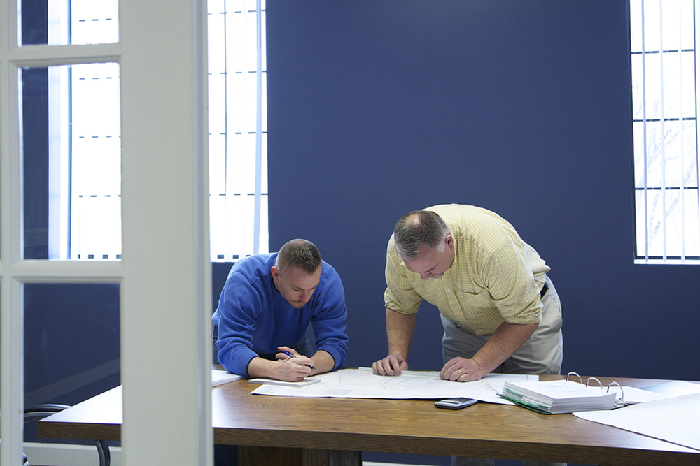 Two men strategizing at a table