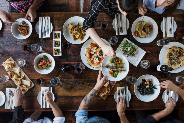 People eating a lot of Italian food