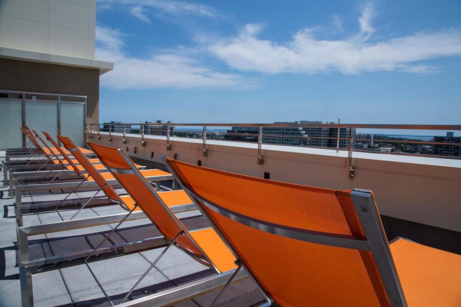 A rooftop with chairs overlooking the city