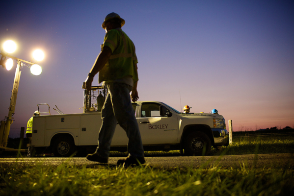 A Boxley employee and Boxley Truck at Night