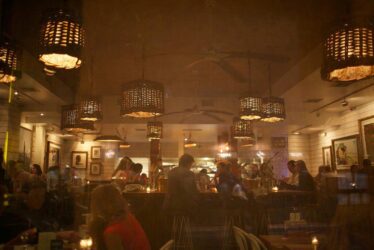 Photograph of a busy restaurant at night. Photograph of a busy restaurant at night.