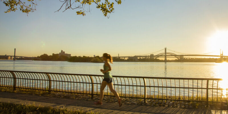 A woman running next to a body of water
