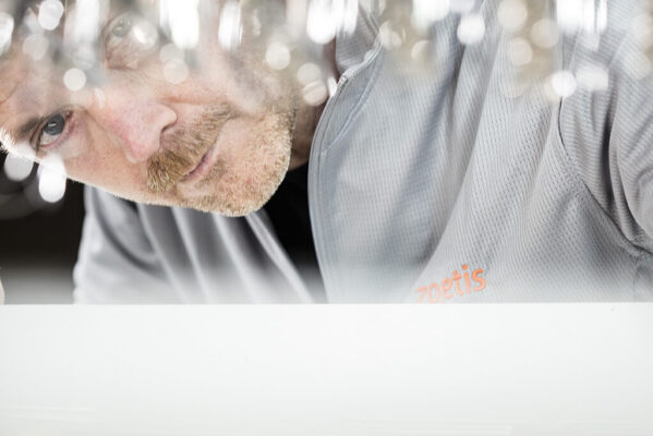 Scientist in a laboratory works on a machine.