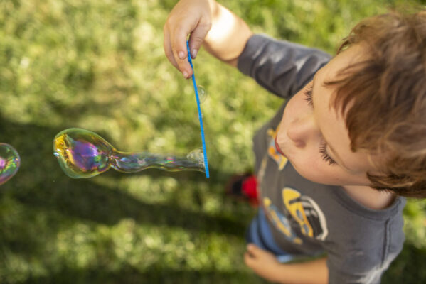 A kid blowing bubbles