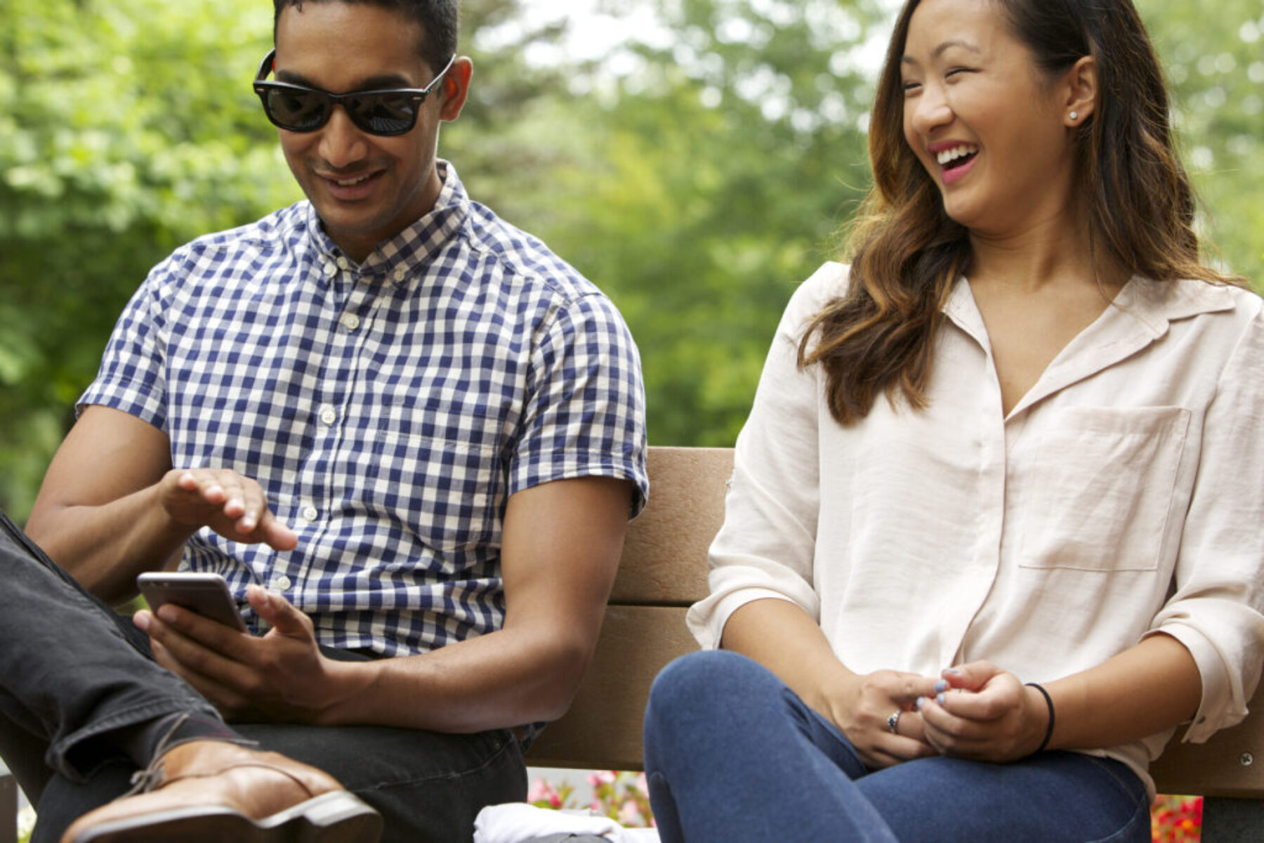 A man and a woman laughing while in conversation with one another