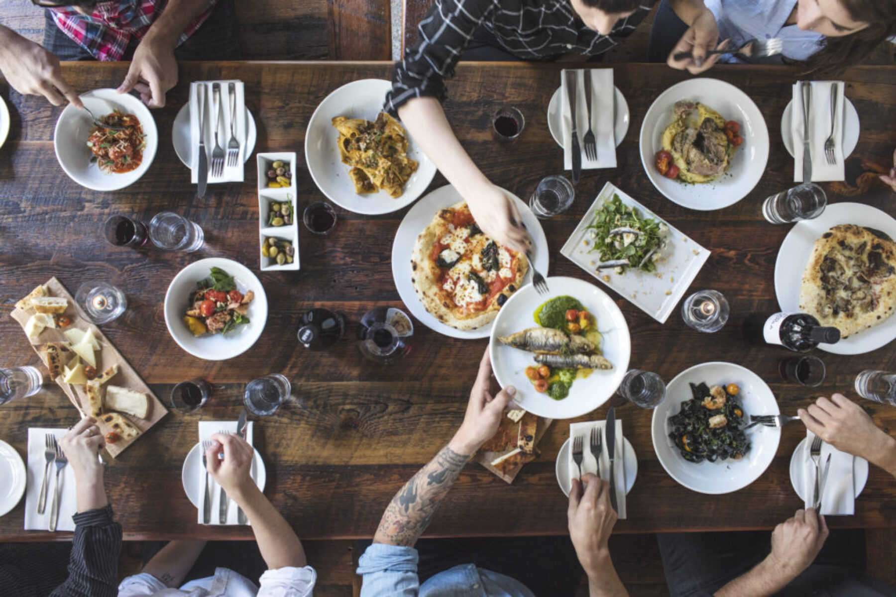 People eating a lot of Italian food