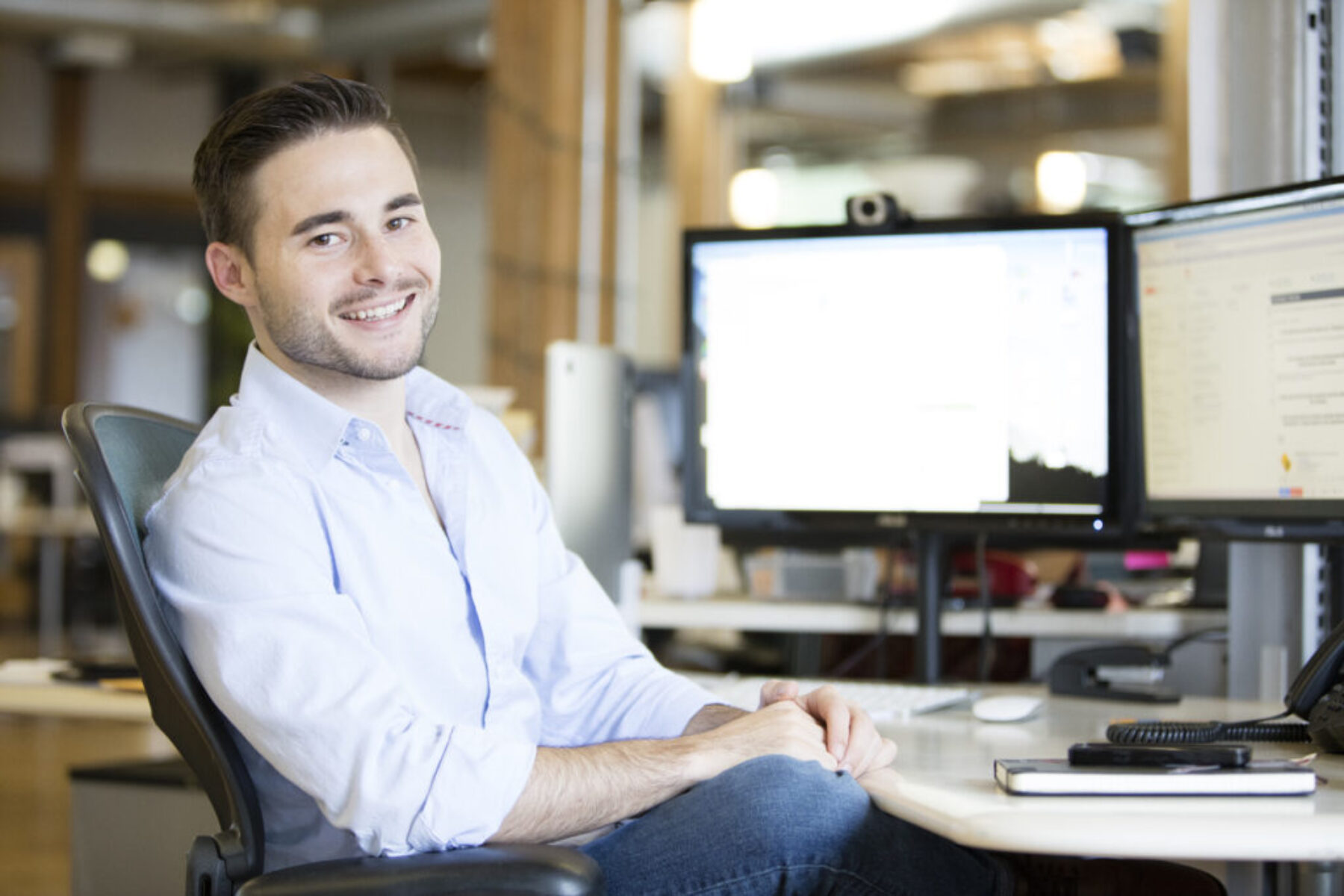 A man working at his desk posing for a picture