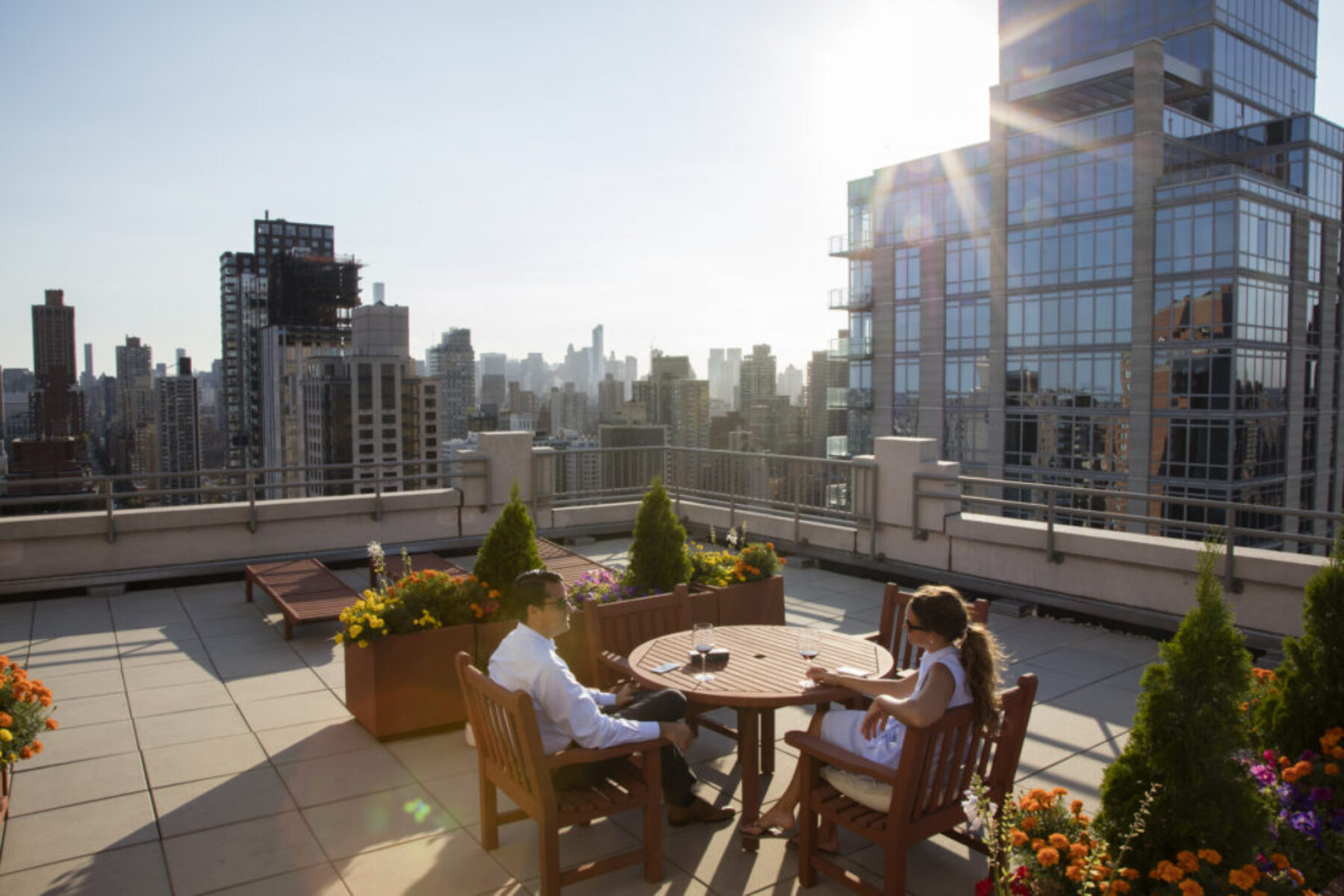 Two people enjoying a glass of wine on a rooftop