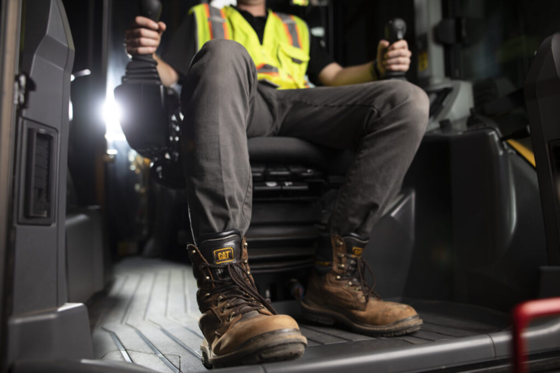 A man operating a Caterpillar machine