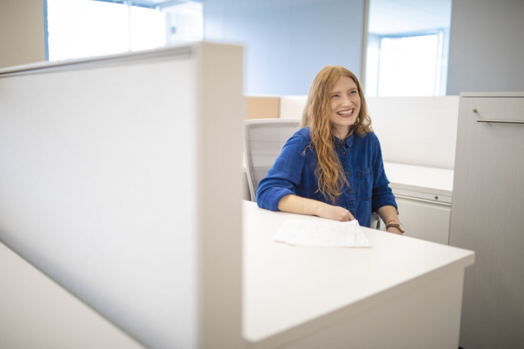 Carolyn Weaver smiling while sitting at a desk