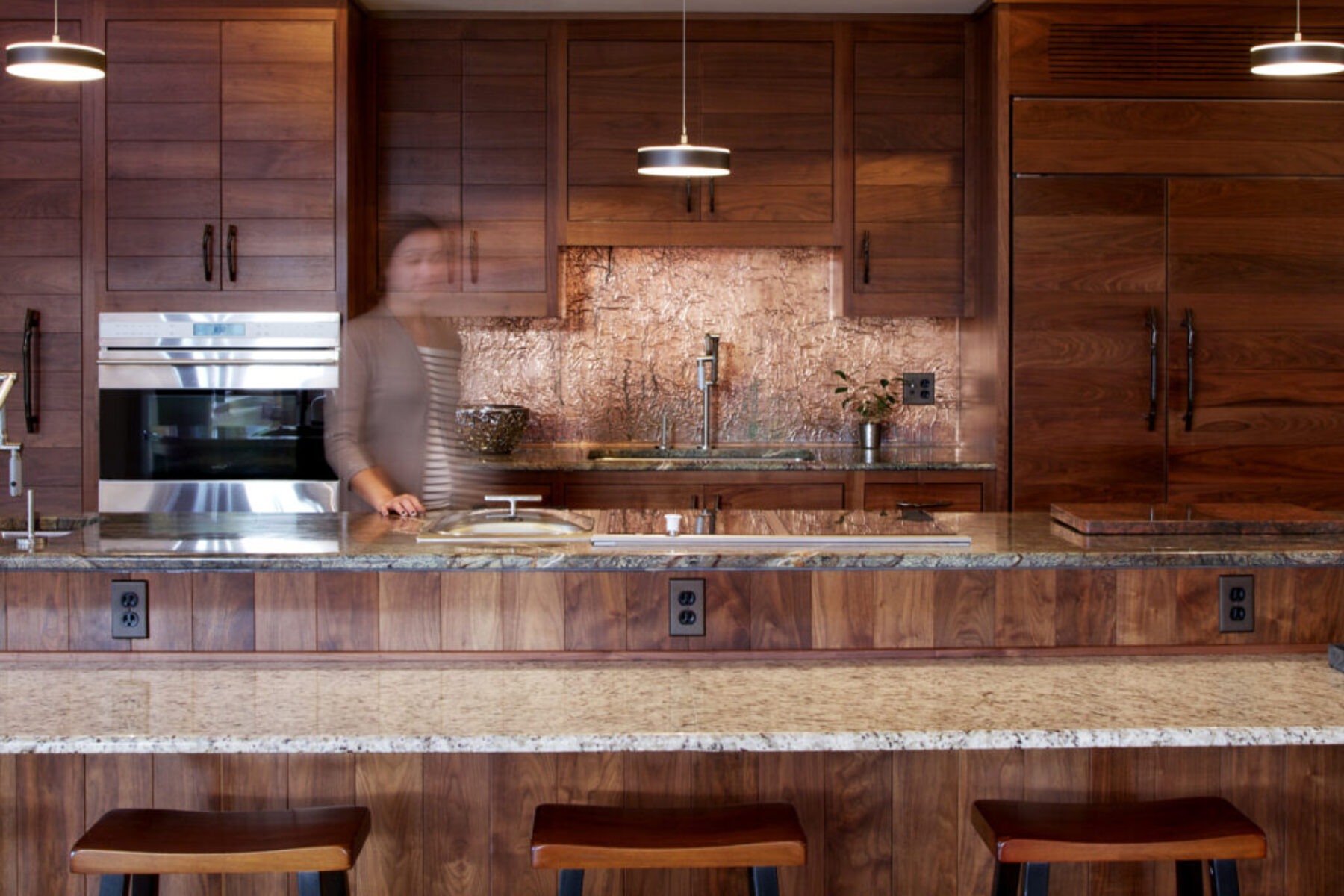 A kitchen with wooden cupboards and granite countertops