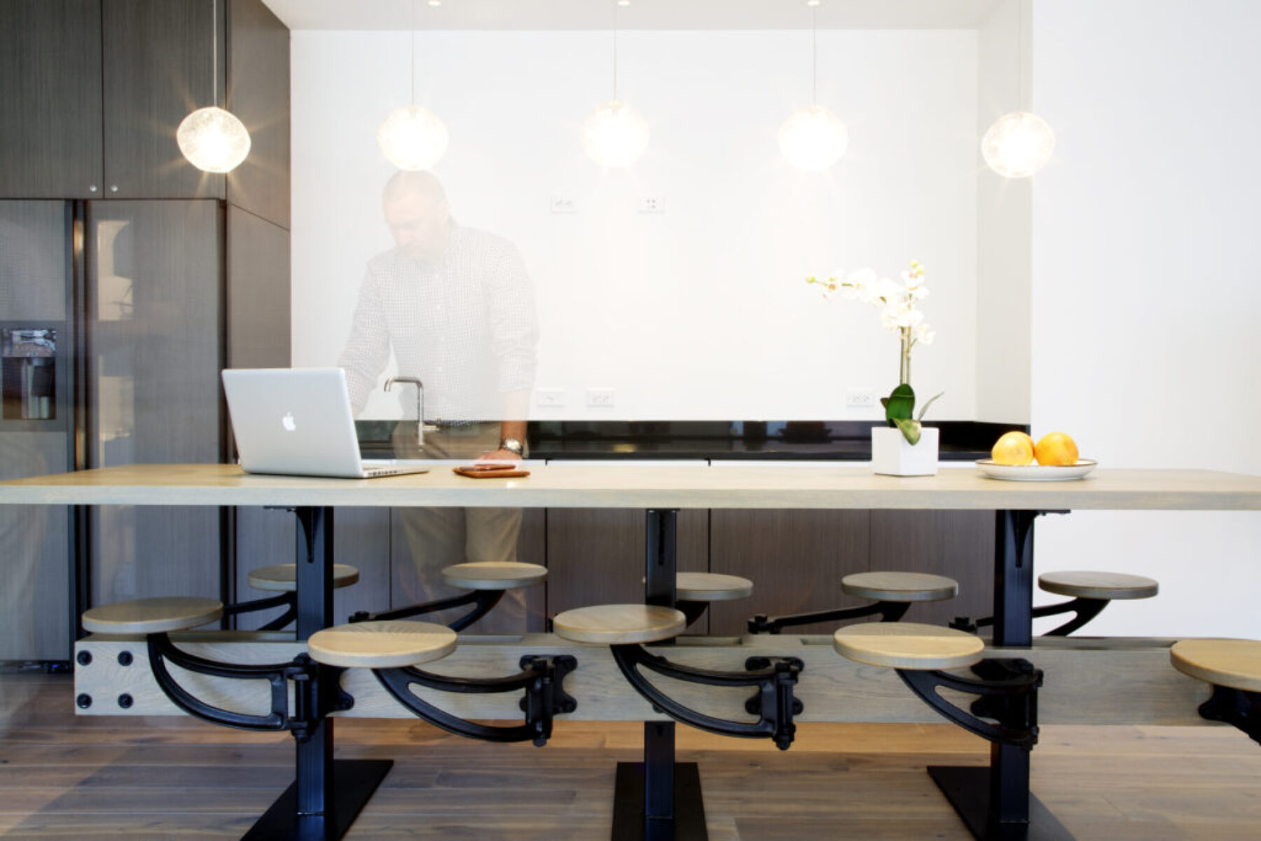 A modern kitchen with a Macbook on the table