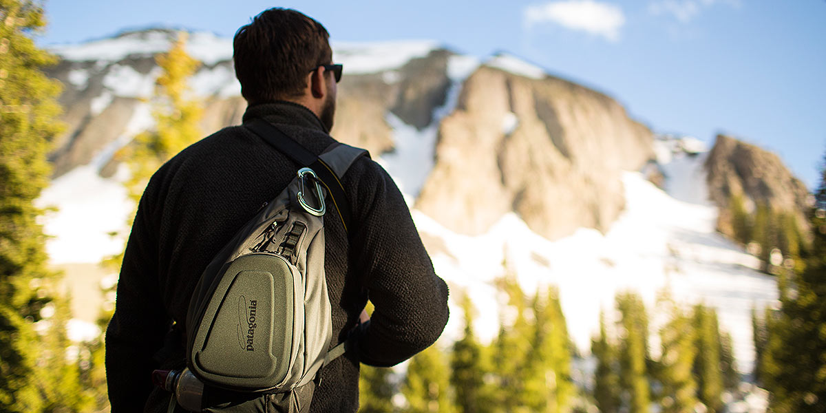 A man facing away with mountains in background