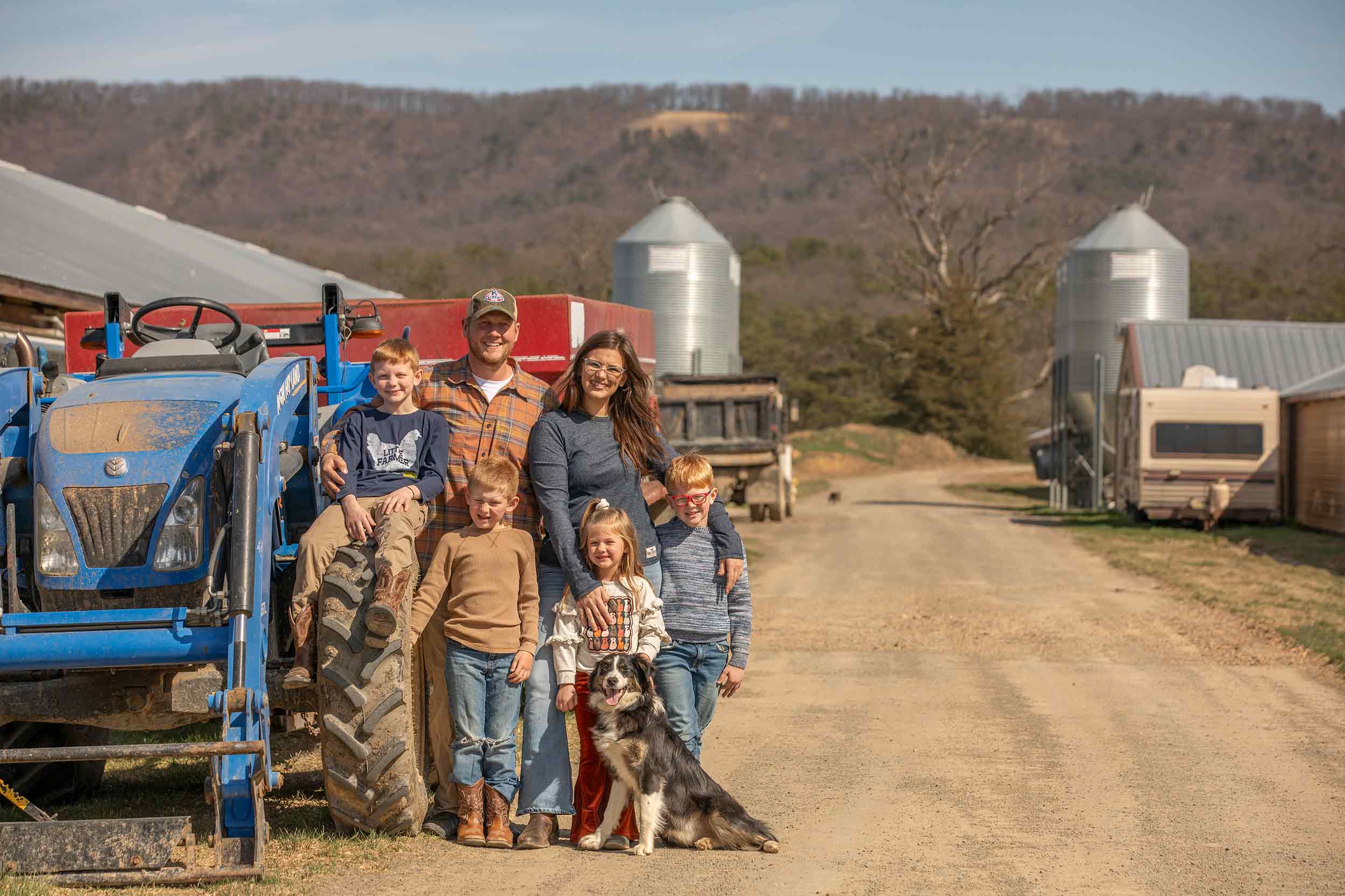 Farmer Focus family photographed beside a tractor on their Virginia farm.