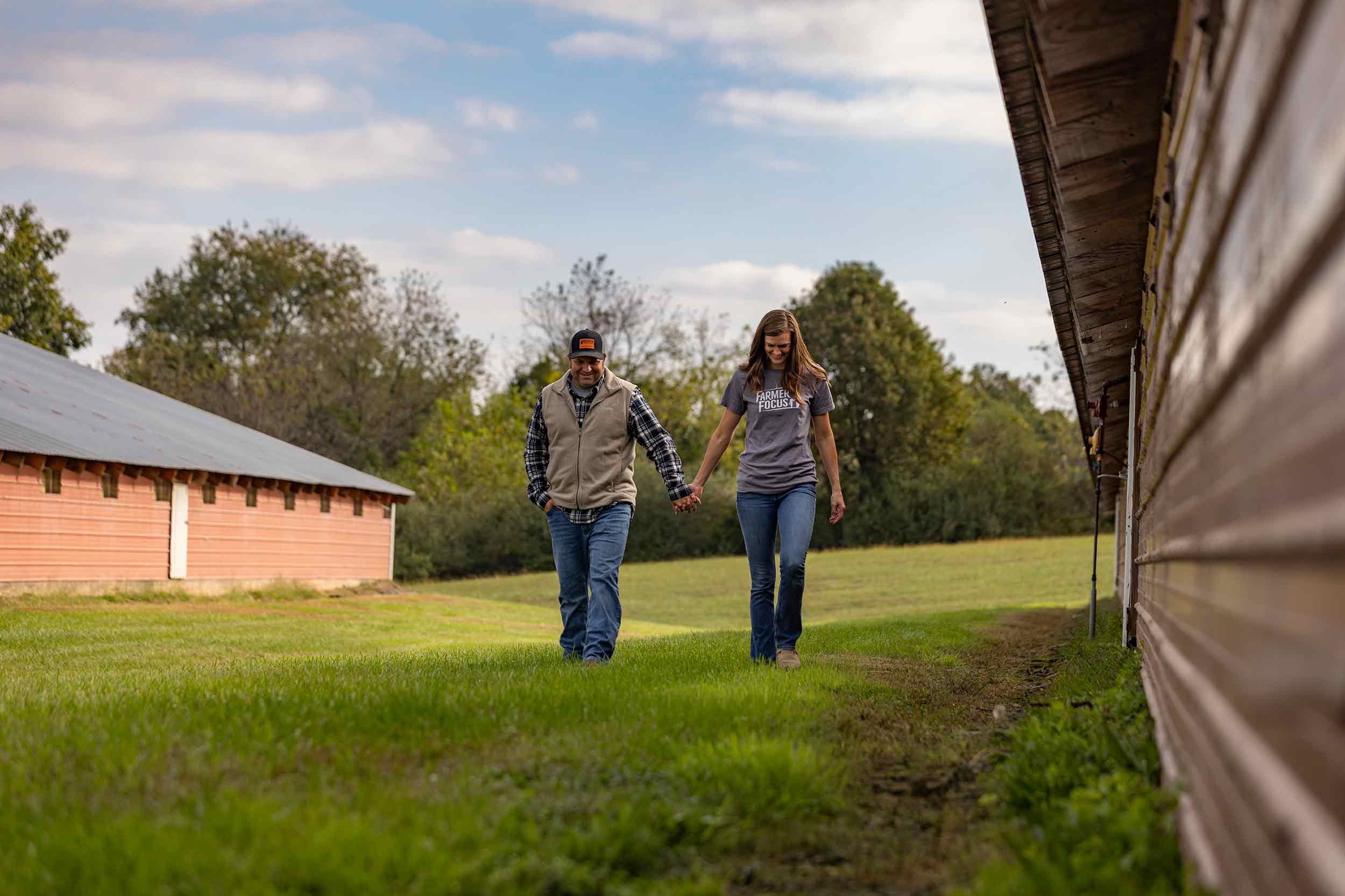 Farmers walking between poultry houses on a Virginia farm during a Farmer Focus commercial photography shoot.