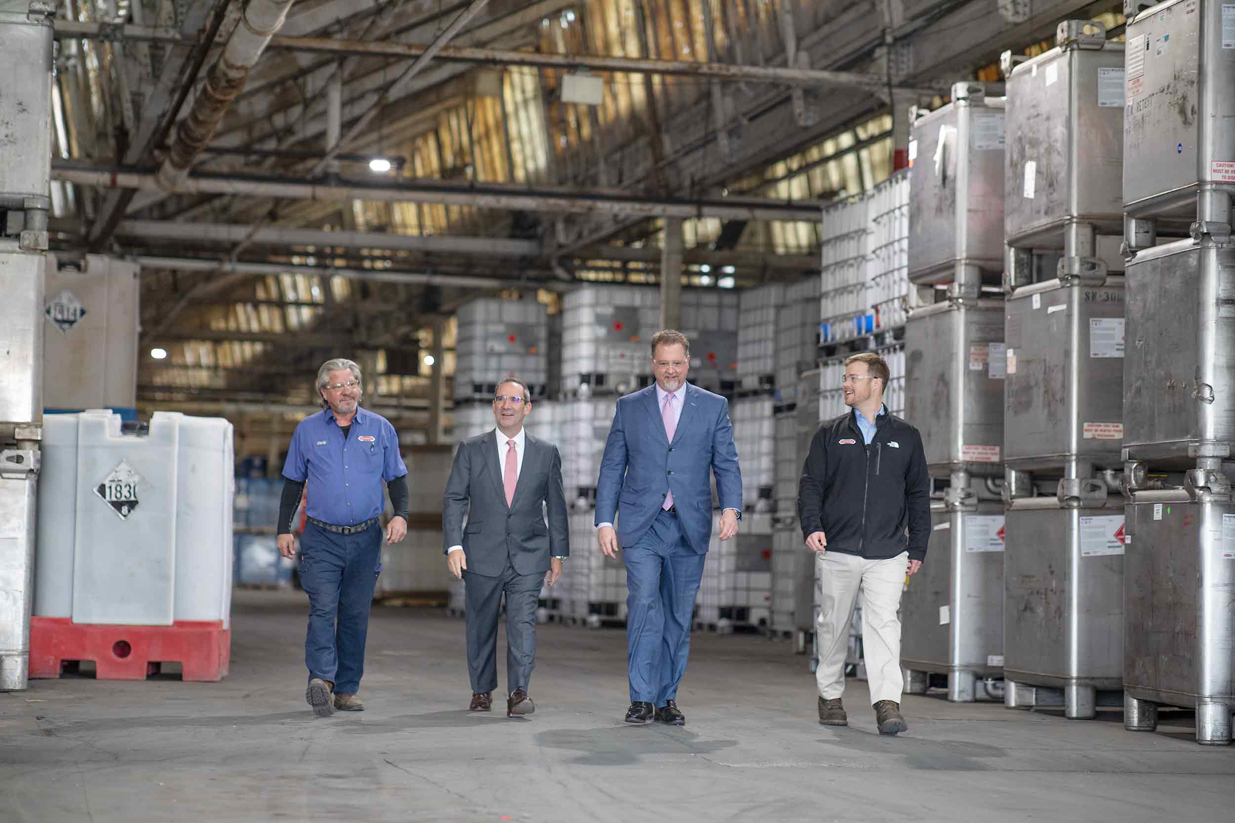 Business leaders and employees walking through a Virginia industrial facility.