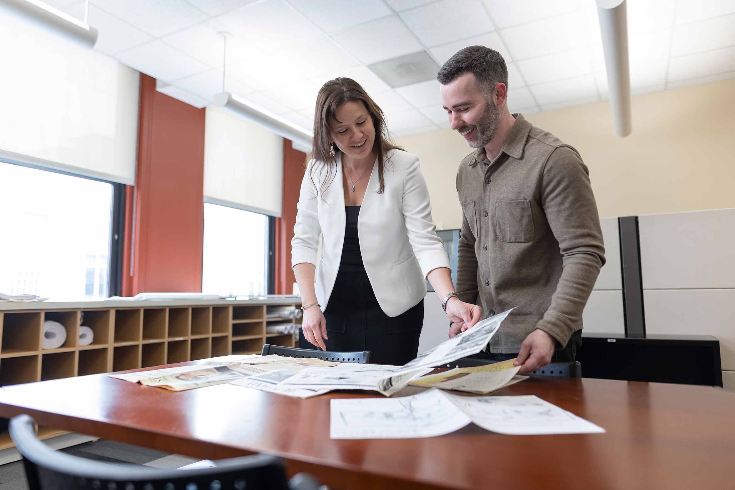 SFCS Architects team members reviewing architectural plans in their office